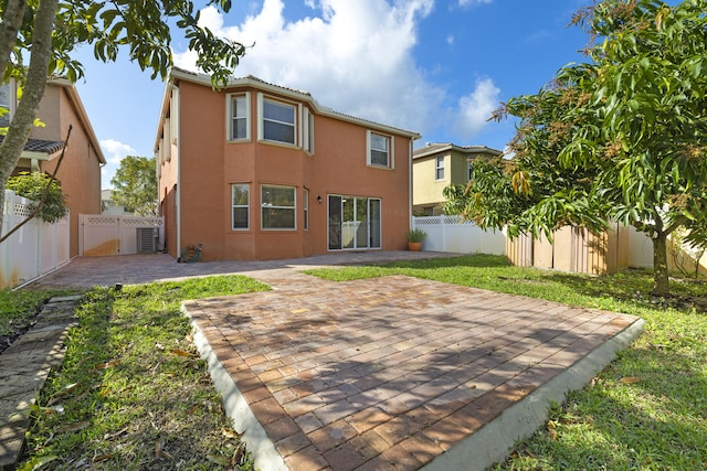 back of property with a patio area, a fenced backyard, and stucco siding