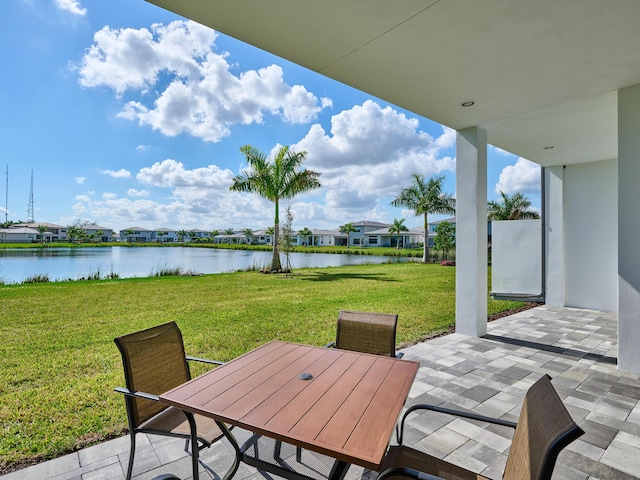 view of patio featuring outdoor dining space and a water view