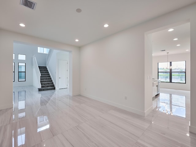 unfurnished room featuring stairs, baseboards, visible vents, and recessed lighting