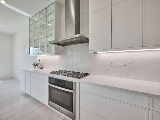 8107 Crystal Downs Ave, Boca Raton, FL 33434 - kitchen featuring appliances with stainless steel finishes, wall chimney exhaust hood, backsplash, white cabinetry, and recessed lighting