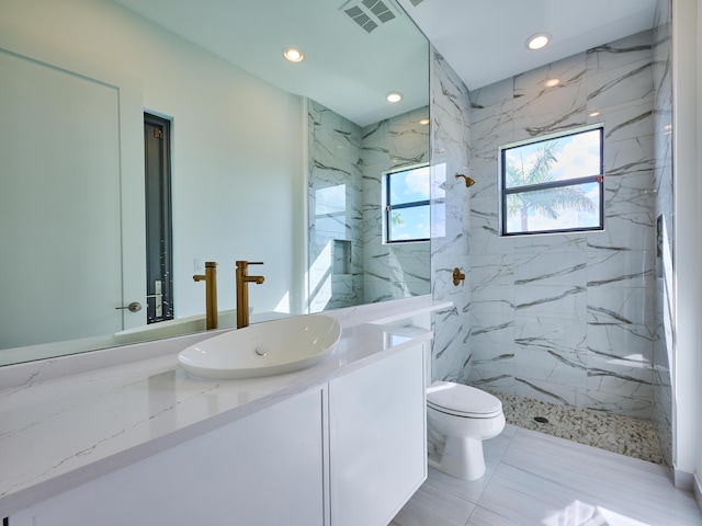 full bath featuring a marble finish shower, recessed lighting, visible vents, toilet, and vanity