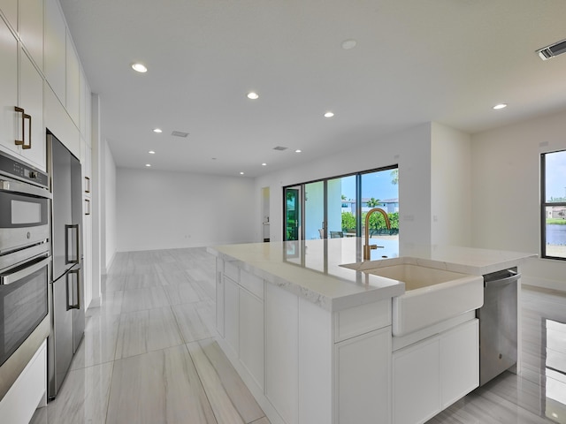 8107 Crystal Downs Ave, Boca Raton, FL 33434 - kitchen featuring stainless steel appliances, recessed lighting, plenty of natural light, open floor plan, and a kitchen island with sink
