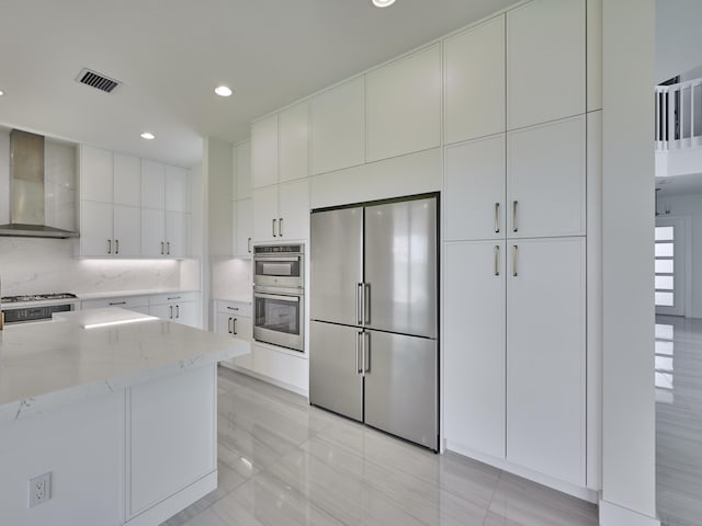 8107 Crystal Downs Ave, Boca Raton, FL 33434 - kitchen with appliances with stainless steel finishes, wall chimney range hood, light stone countertops, white cabinets, and recessed lighting
