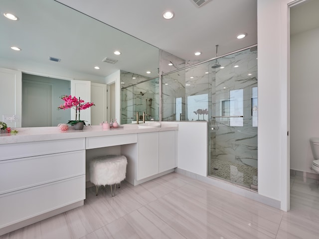 bathroom with toilet, a marble finish shower, visible vents, and vanity