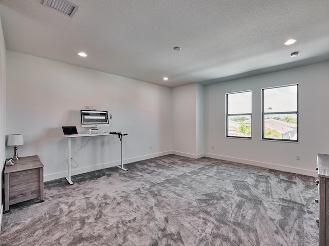 empty room featuring baseboards, visible vents, a textured ceiling, carpet flooring, and recessed lighting