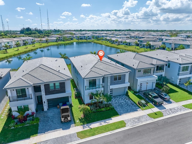 birds eye view of property with a water view and a residential view