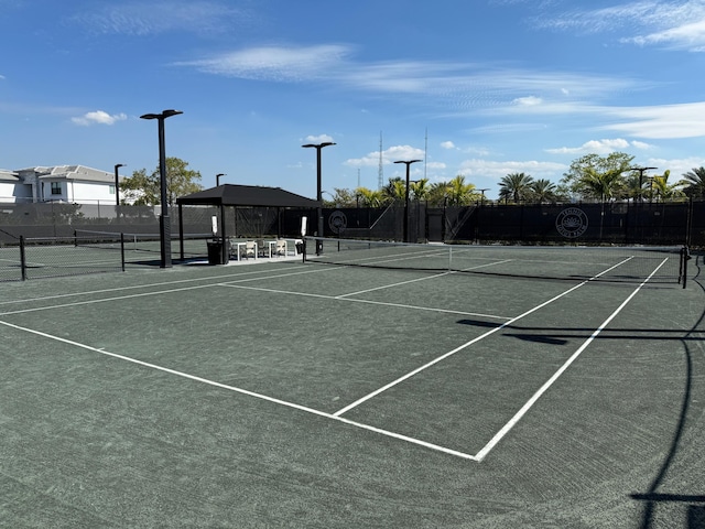 view of tennis court featuring fence