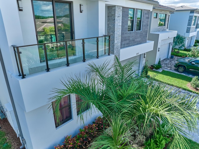 exterior space featuring an attached garage and stucco siding