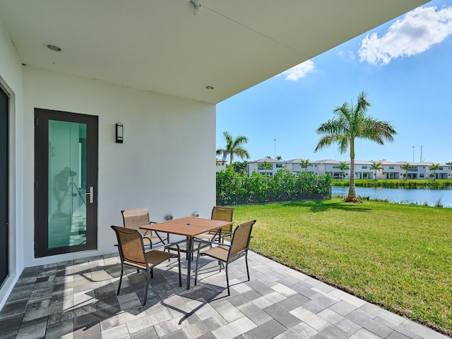 view of patio / terrace featuring outdoor dining area and a water view