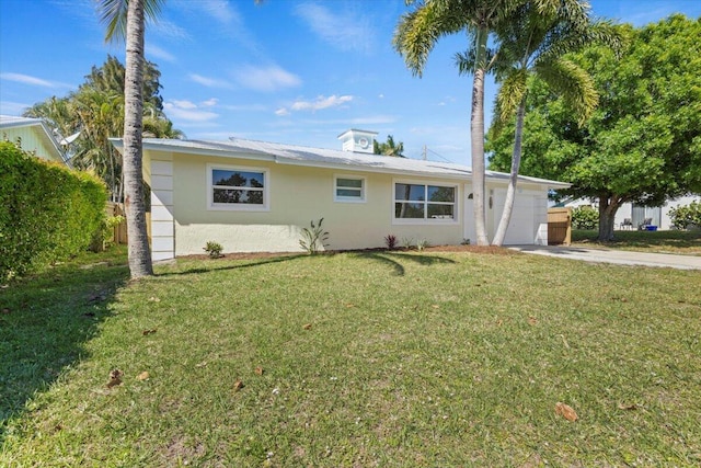 single story home featuring stucco siding, an attached garage, driveway, and a front yard