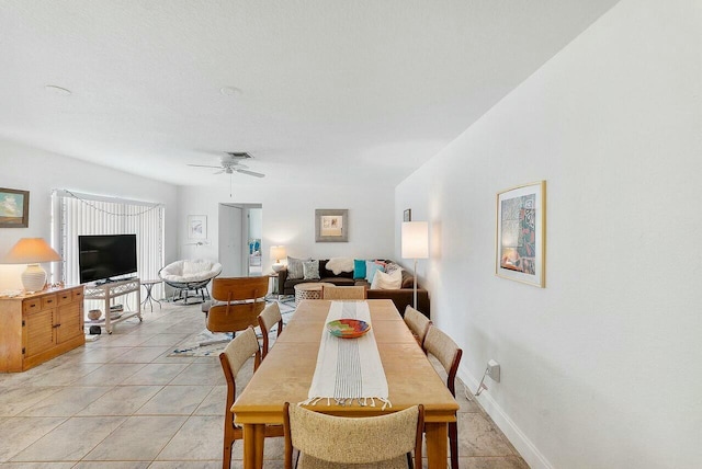 dining space featuring ceiling fan, light tile patterned flooring, visible vents, and baseboards