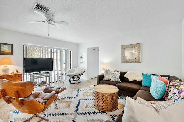 8202 Ambach Way, Hypoluxo, FL 33462 - living room featuring a ceiling fan and a textured ceiling