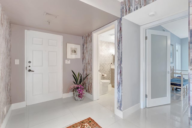 entrance foyer with tile patterned flooring and baseboards