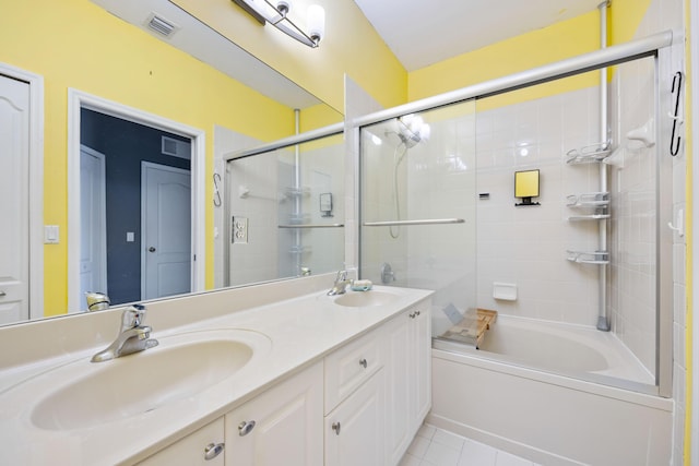 full bathroom with double vanity, combined bath / shower with glass door, a sink, and visible vents