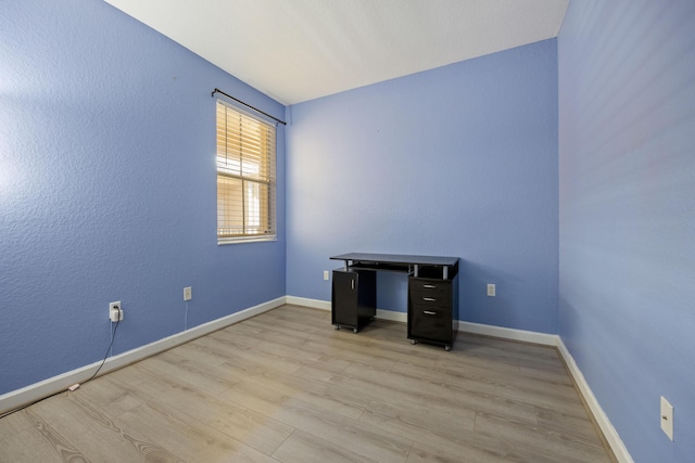 unfurnished room featuring light wood-style flooring and baseboards