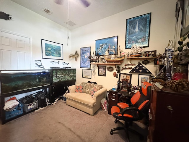 carpeted home office featuring visible vents and ceiling fan