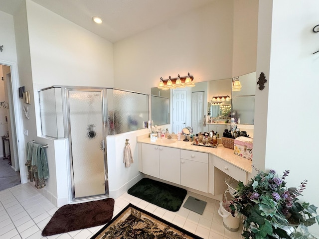 full bathroom with vanity, tile patterned floors, a stall shower, and a towering ceiling