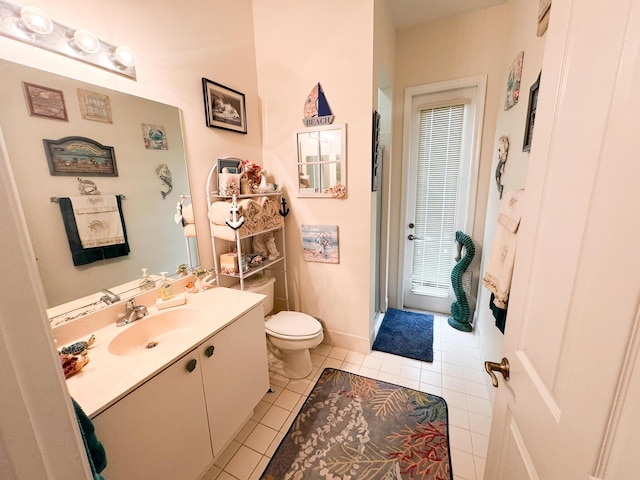 full bathroom featuring tile patterned flooring, baseboards, toilet, a stall shower, and vanity