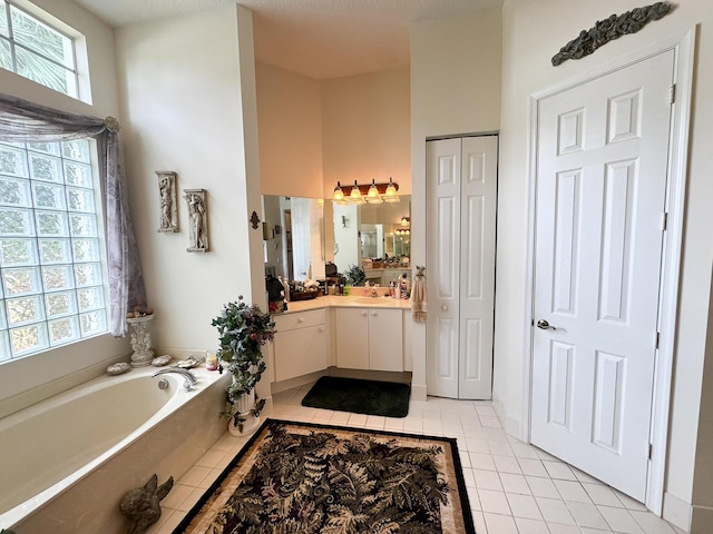 full bathroom with vanity, tile patterned floors, and a garden tub