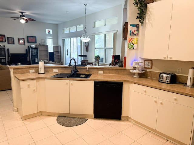 kitchen featuring a peninsula, a sink, pendant lighting, dishwasher, and open floor plan