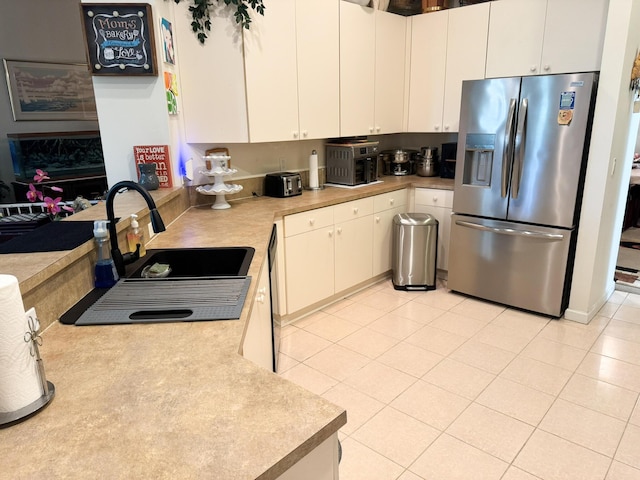 224 NW Pleasant Grove Way, Port Saint Lucie, FL 34986 - kitchen with a sink, light countertops, dishwasher, stainless steel refrigerator with ice dispenser, and white cabinetry