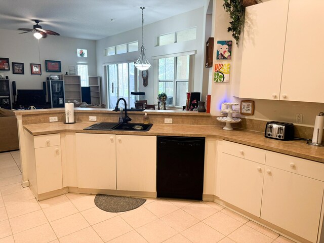 kitchen with stainless steel microwave, light countertops, light tile patterned floors, white cabinetry, and black / electric stove