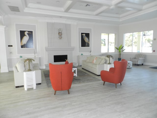 living area with wood finished floors, visible vents, coffered ceiling, a fireplace, and crown molding