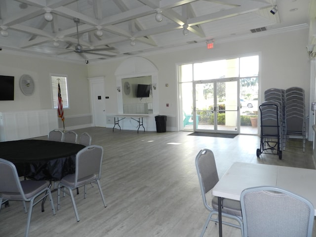 dining room featuring visible vents, ceiling fan, baseboards, beamed ceiling, and light wood-style floors