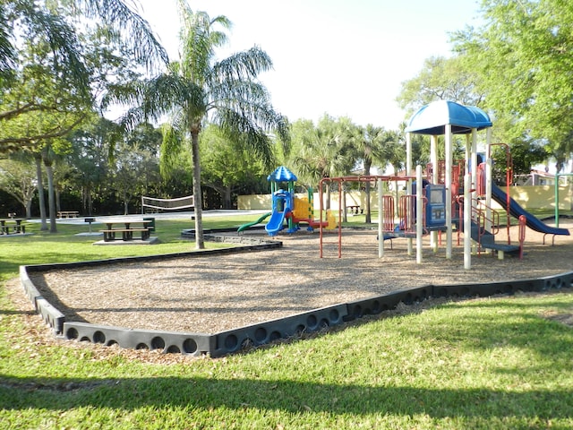 community play area with a lawn and volleyball court