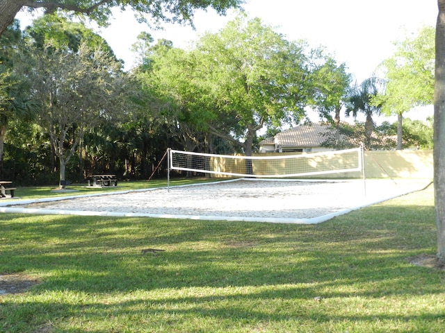 view of community featuring volleyball court and a yard