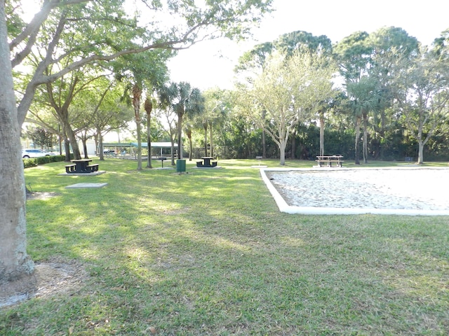 surrounding community featuring a yard and volleyball court