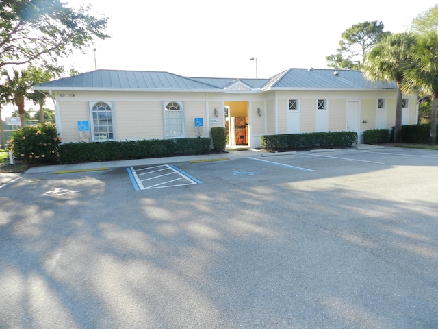 view of building exterior with uncovered parking