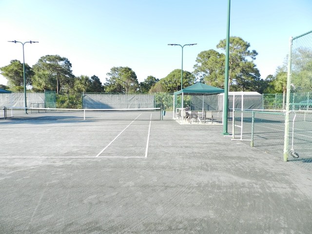 224 NW Pleasant Grove Way, Port Saint Lucie, FL 34986 - view of tennis court featuring fence