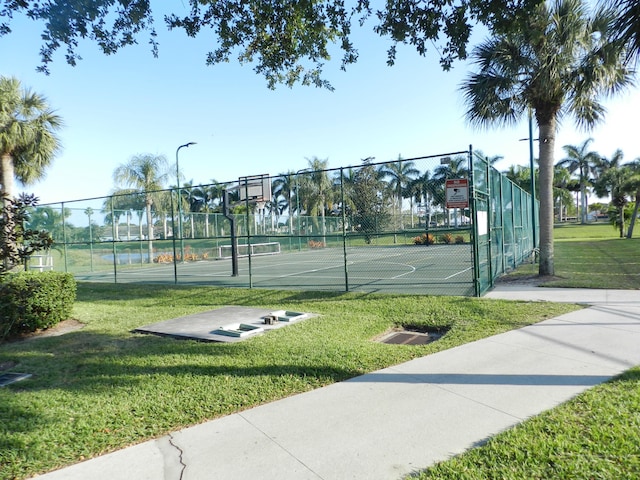 view of sport court with community basketball court, a yard, and fence