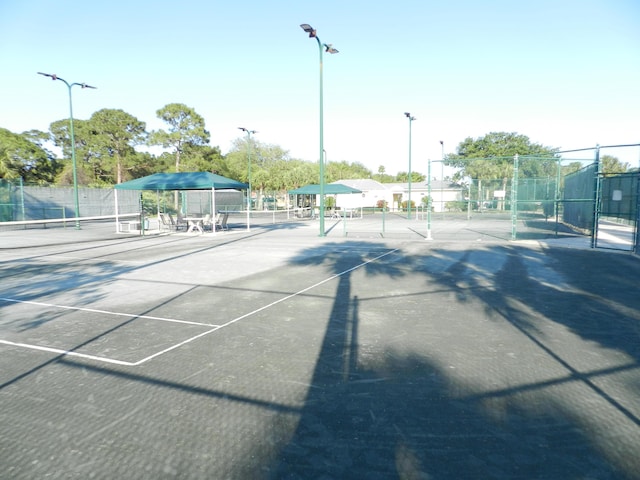 view of tennis court with fence