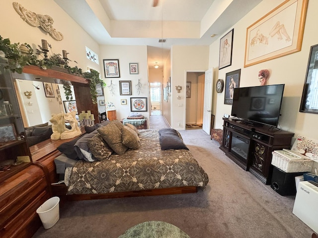 carpeted living room with visible vents and a tray ceiling