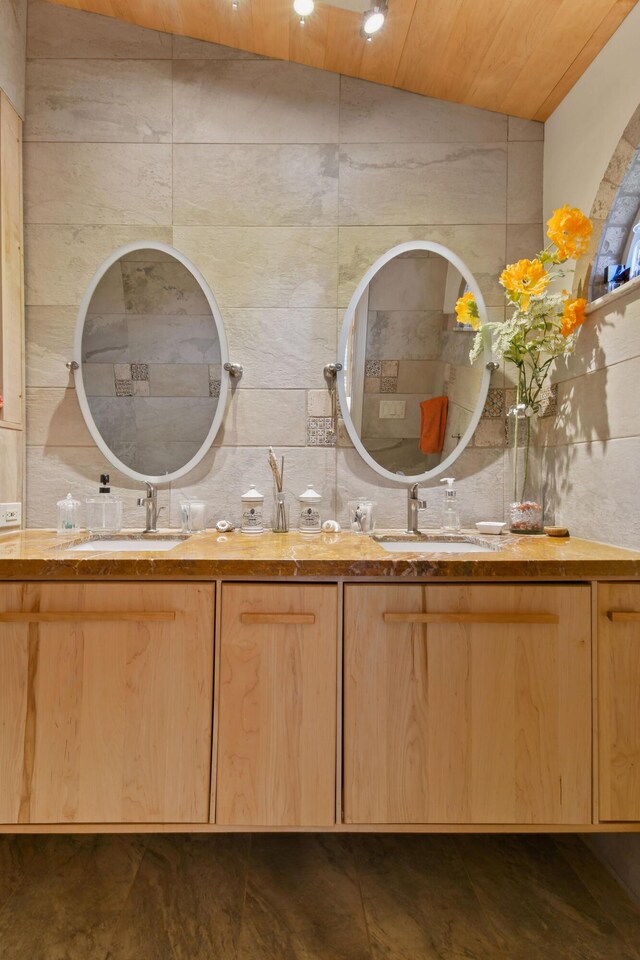 bathroom featuring a sink and double vanity