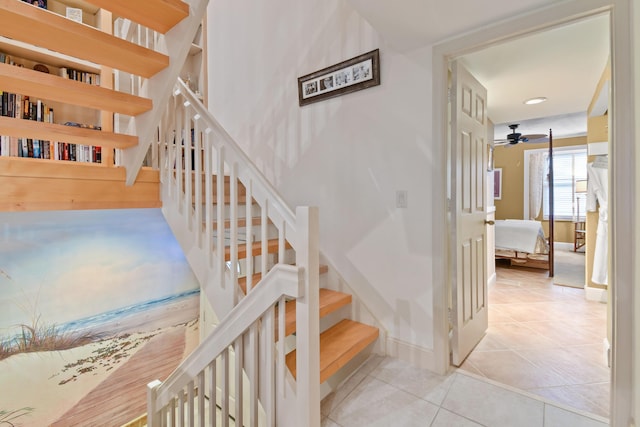 staircase featuring baseboards and tile patterned floors