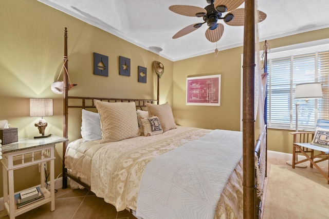 tiled bedroom with crown molding, a ceiling fan, and baseboards