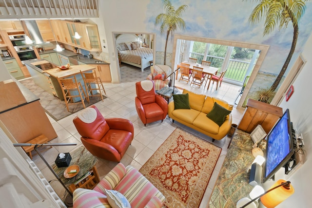 living room featuring a high ceiling and light tile patterned flooring