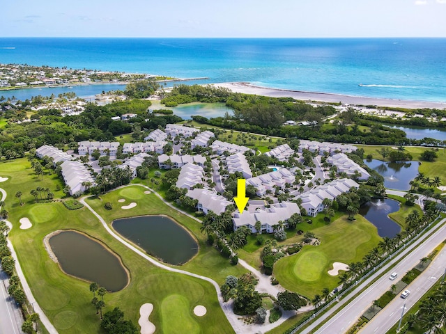 birds eye view of property with a water view and golf course view