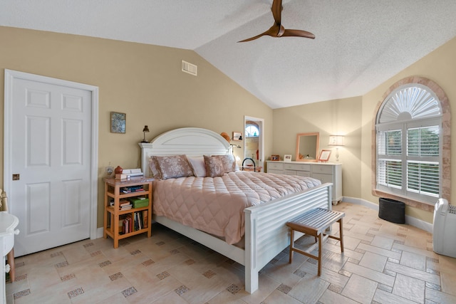 bedroom with lofted ceiling, a textured ceiling, a ceiling fan, visible vents, and baseboards