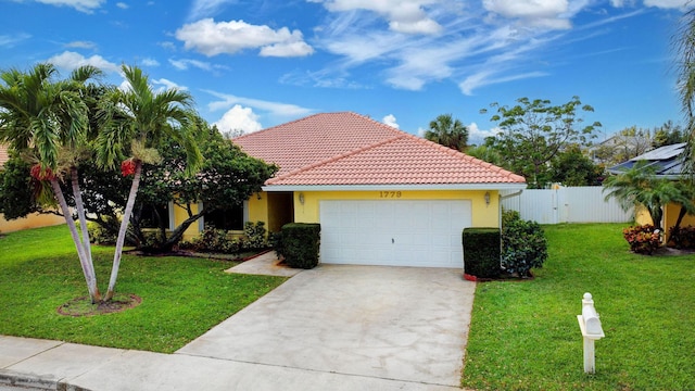 view of front facade with a garage, a tiled roof, a front lawn, and stucco siding