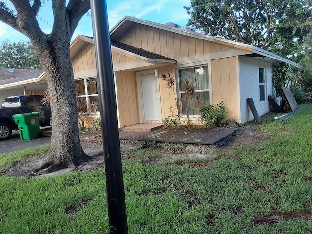 back of house with a lawn