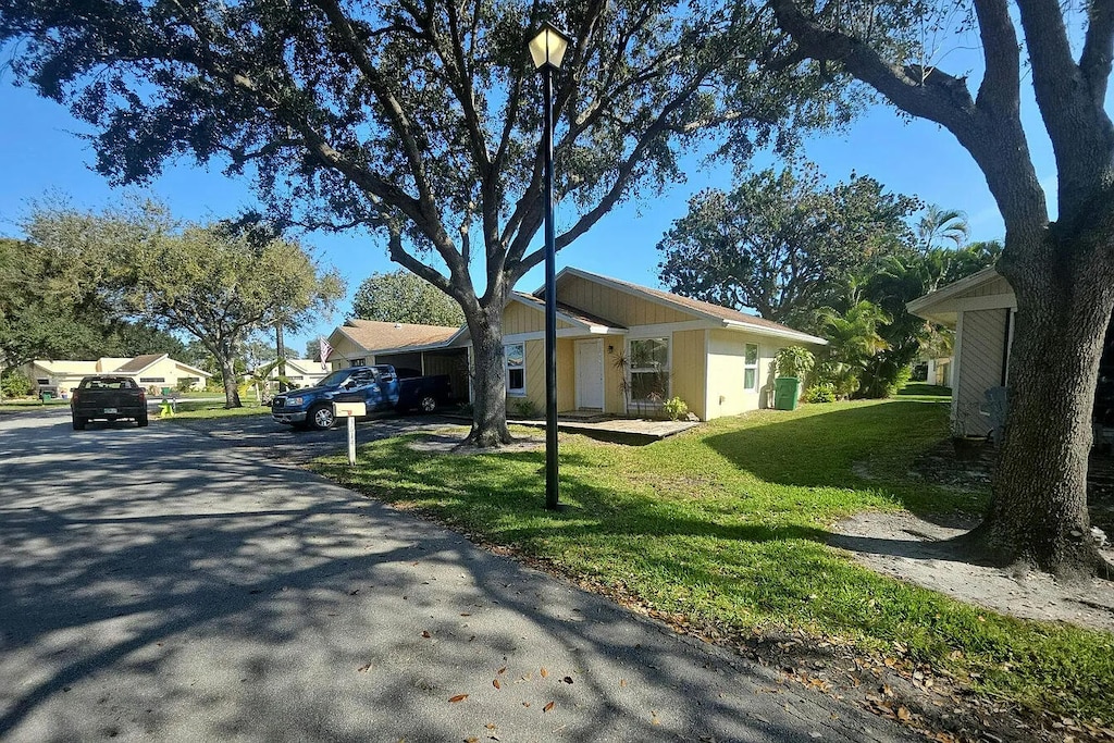 exterior space with a front lawn and a residential view