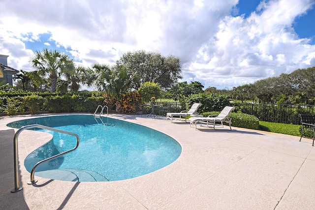 view of pool featuring fence, a fenced in pool, and a patio