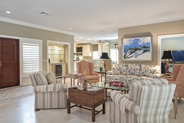 living area with a dry bar, recessed lighting, visible vents, ornamental molding, and beverage cooler