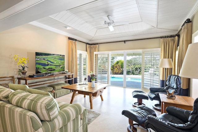 living area featuring ceiling fan, a tray ceiling, and crown molding