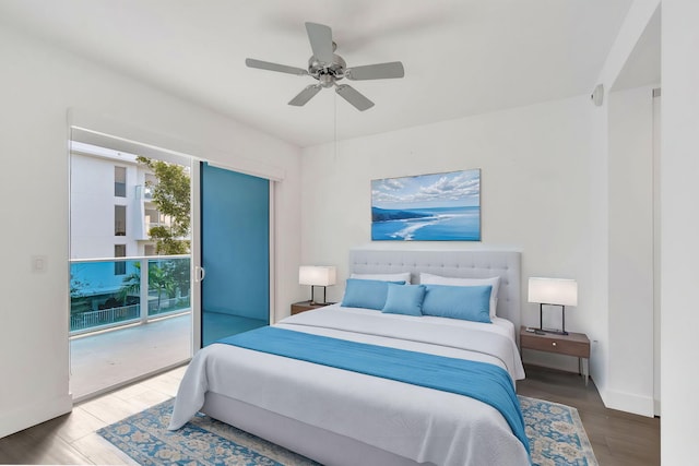 bedroom featuring access to exterior, a ceiling fan, baseboards, and wood finished floors