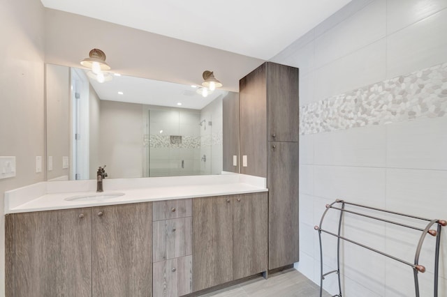 bathroom featuring a stall shower and vanity